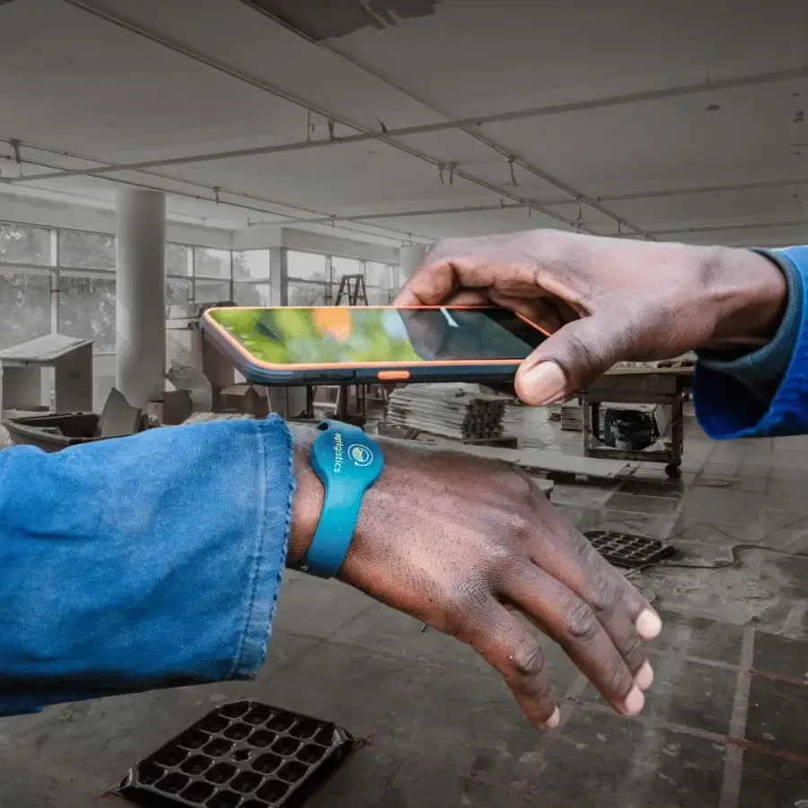 Construction worker clocking in with an RFID wristband using a handheld device